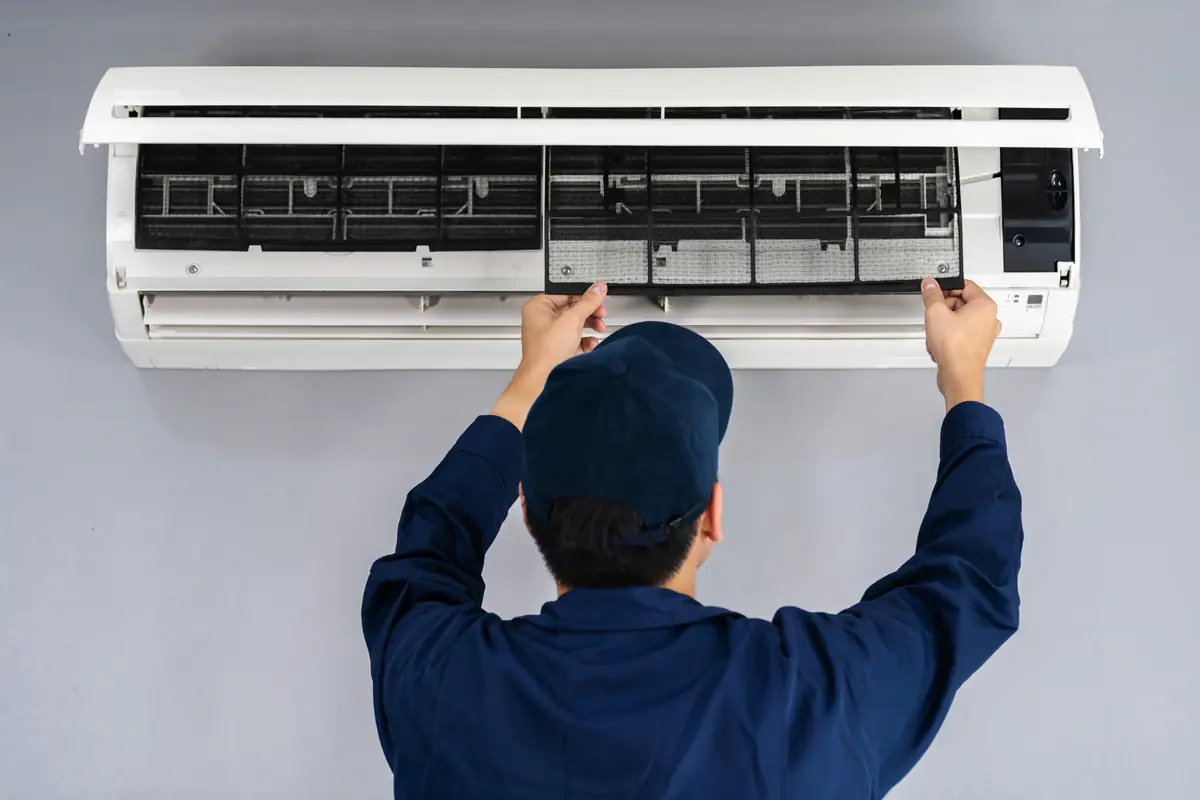 Swift Serve technician cleaning an AC unit